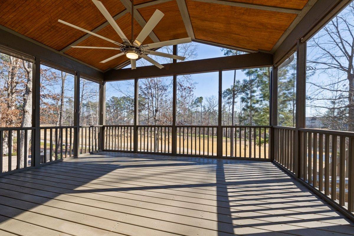 A covered rear deck with ceiling fans and timber decking