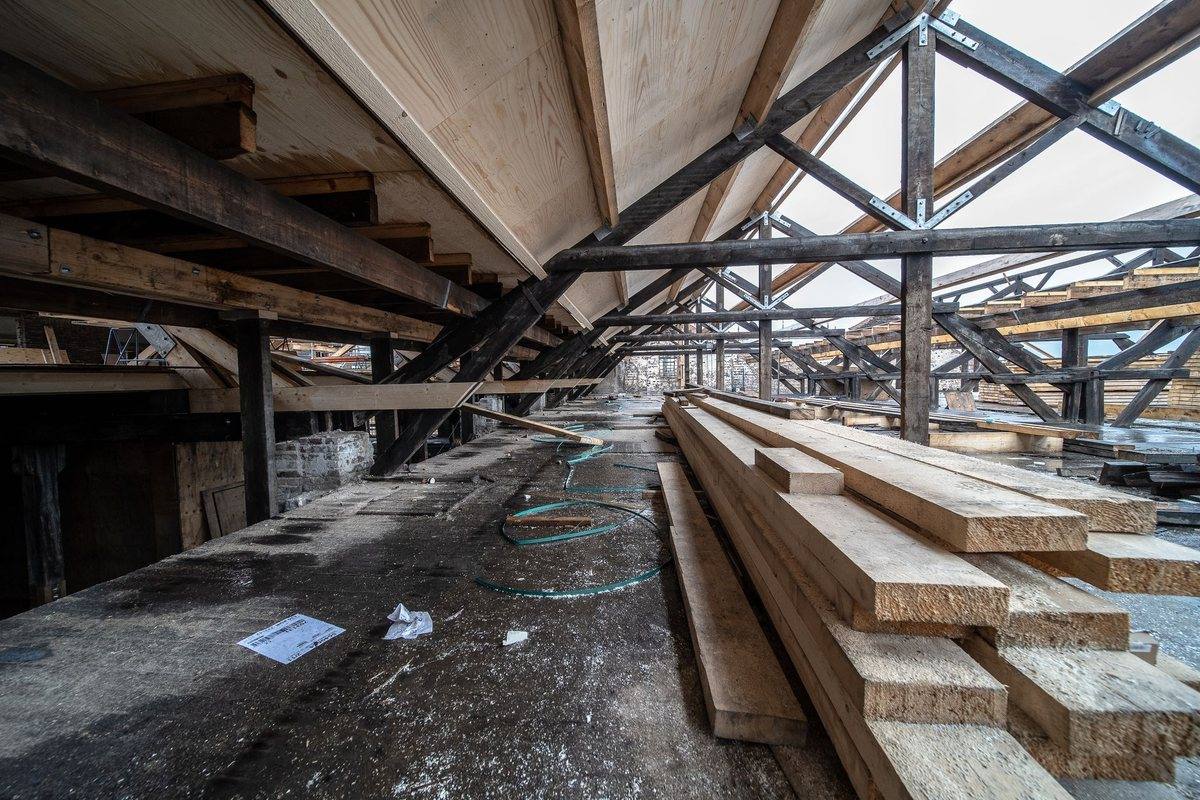 Exposed timber trusses inside a roof structure