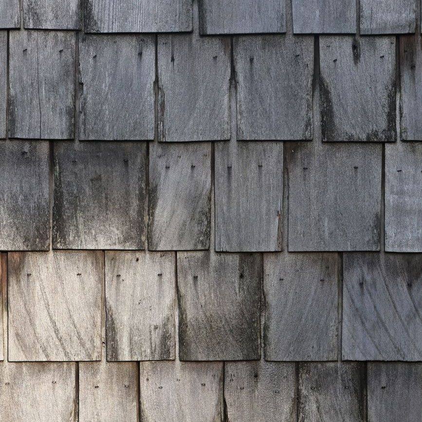 Weathered silver-gray cedar shingles in overlapping courses
