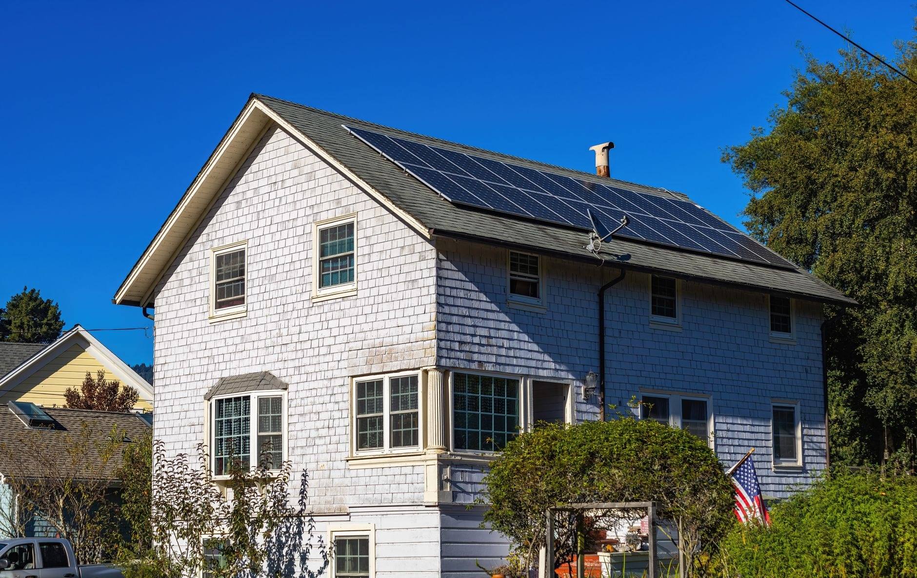 Gray shingled home after cedar re-roof and window replacement