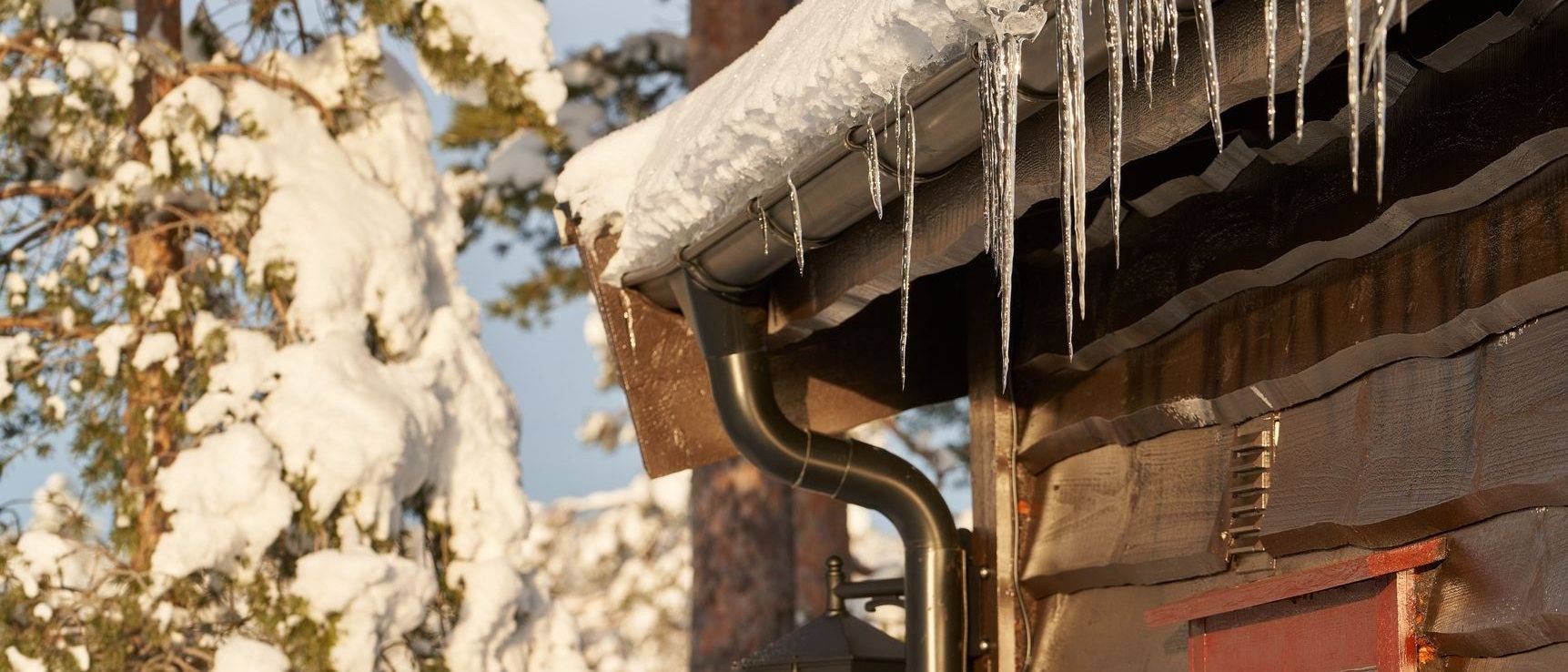 Icicles hanging from the gutter of a house in winter