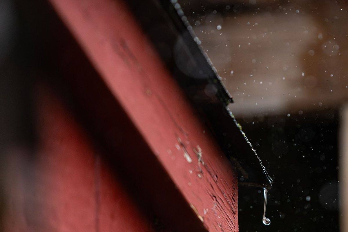 Rainwater running off a roof edge and gutter