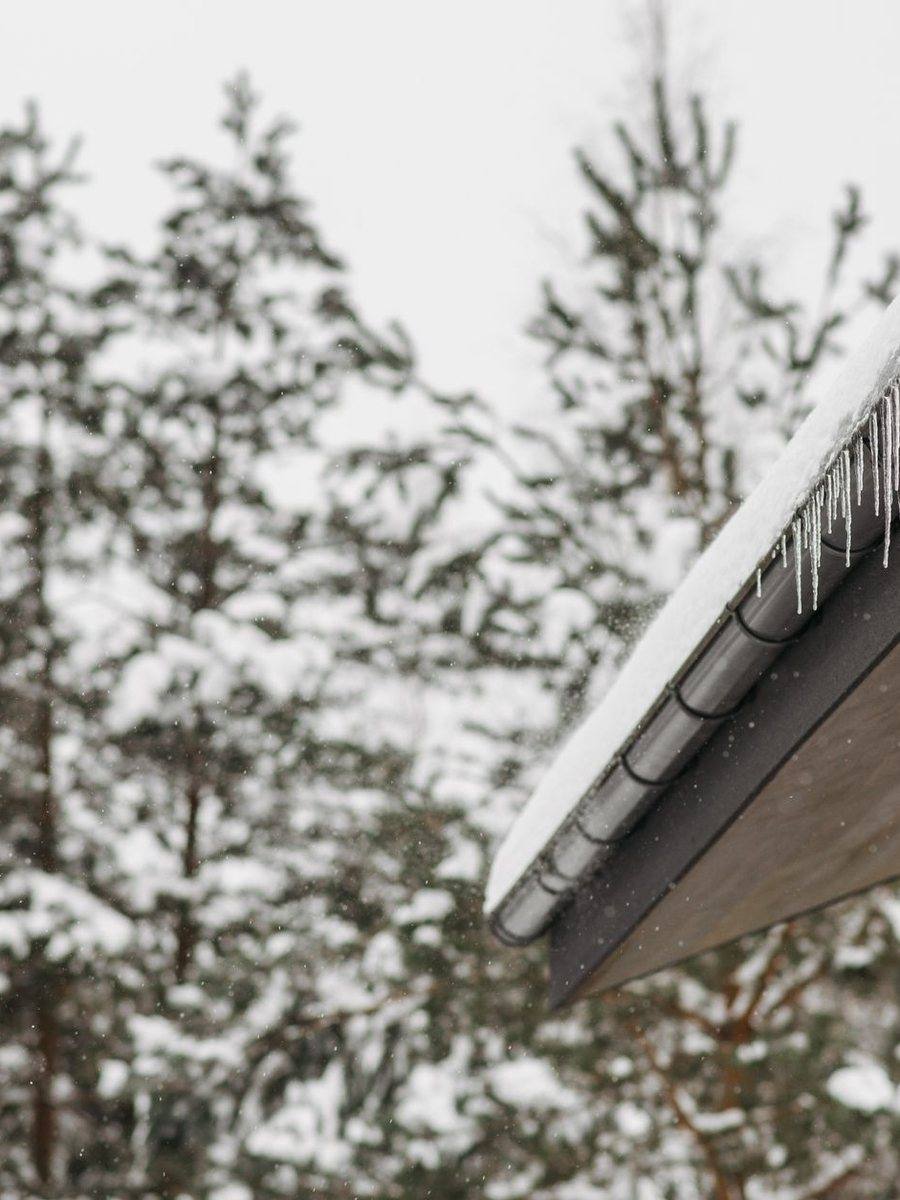Snow and ice built up along a roof edge in winter