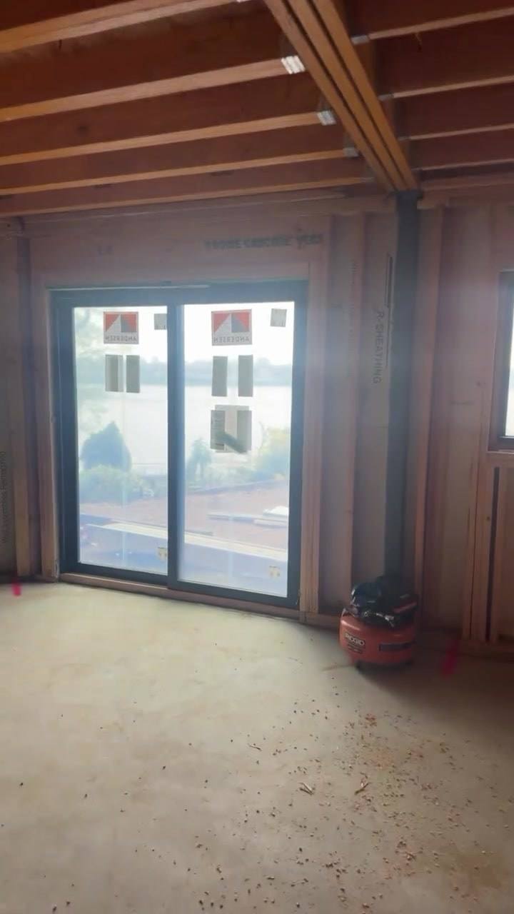 The lower level of the Edgewater house during framing, Andersen sliding doors open onto the Hudson River