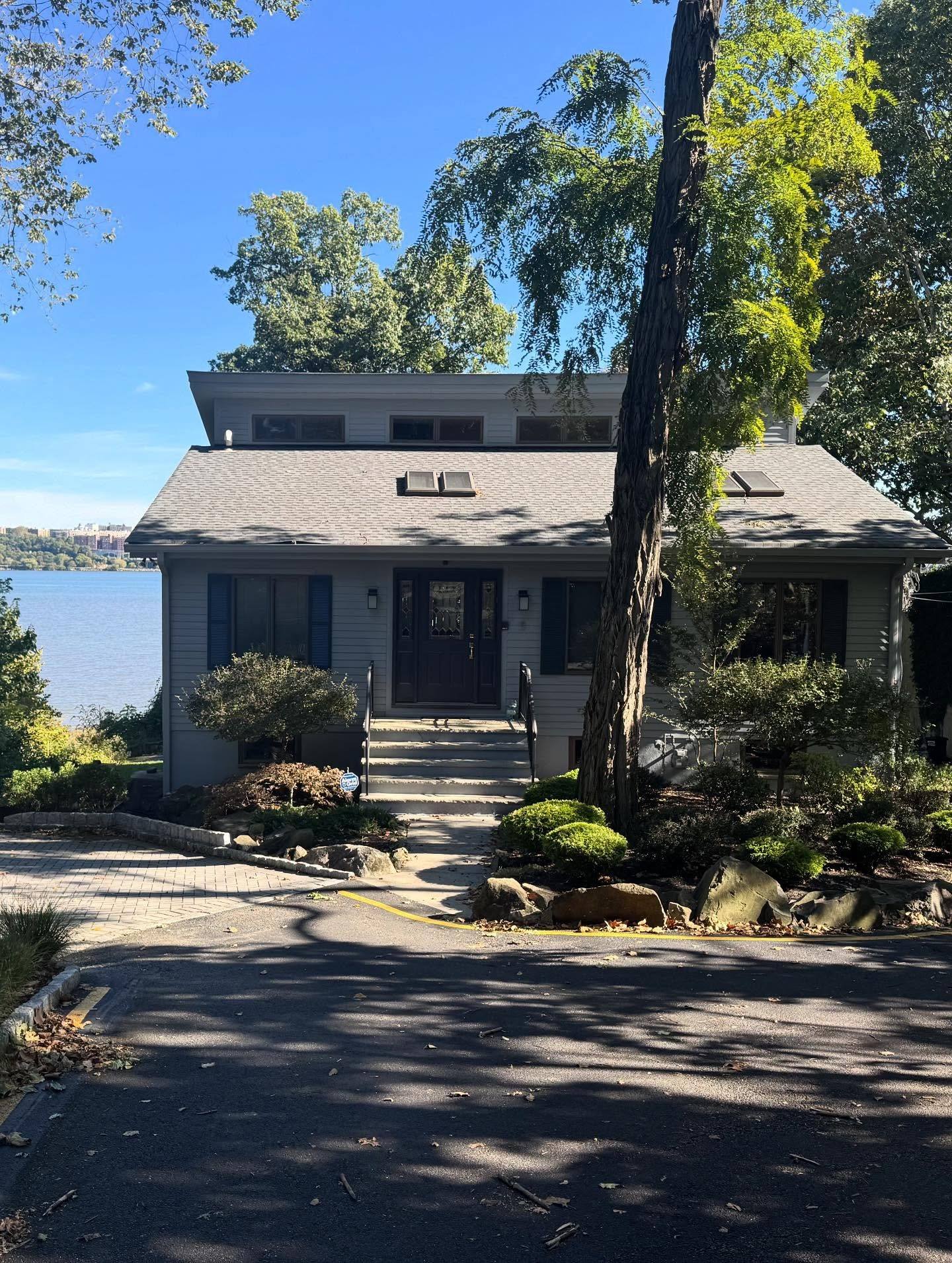 The front of the Edgewater house after the repaint in Benjamin Moore Sweatshirt Gray, the Hudson behind it