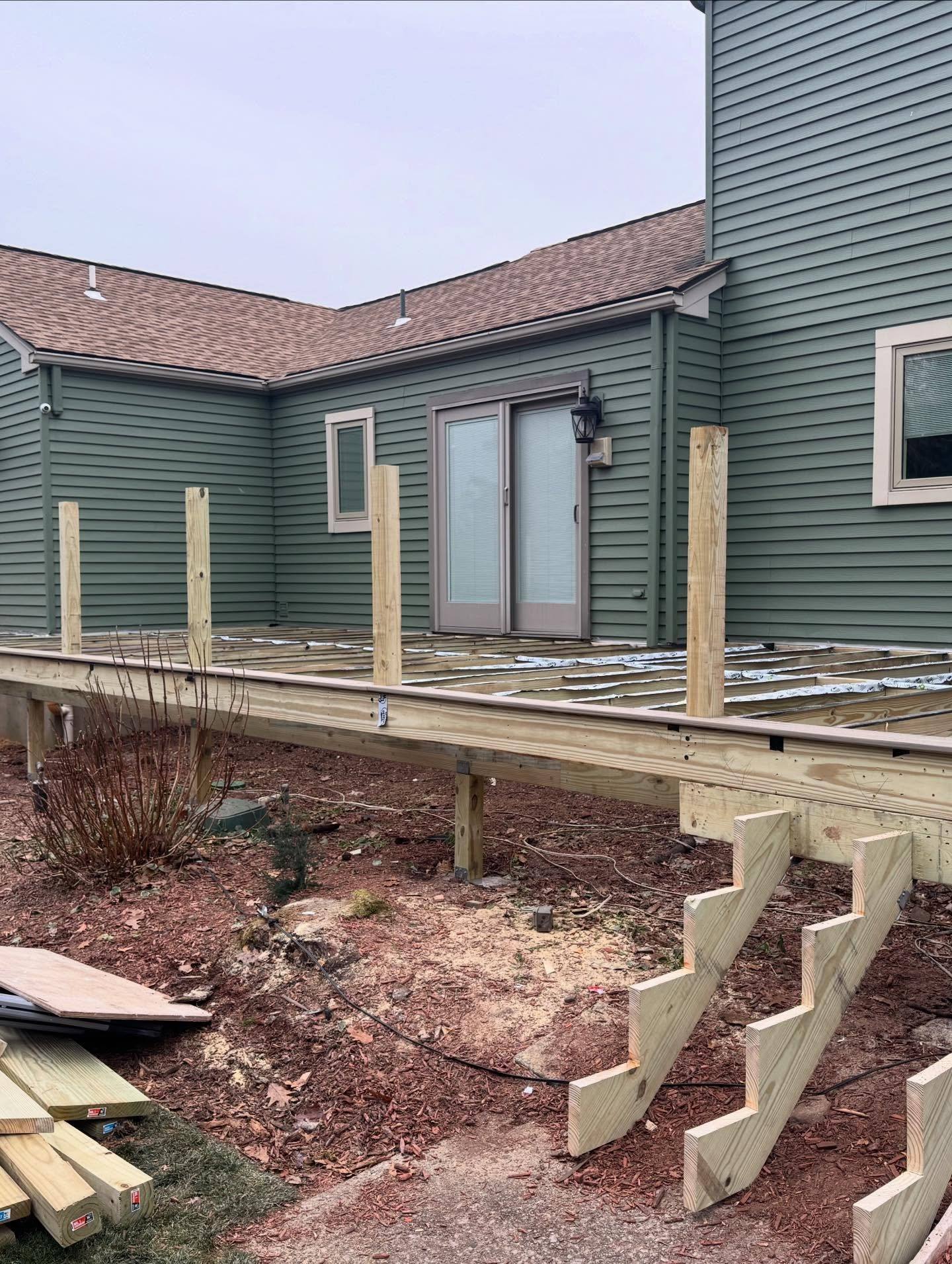 New pressure-treated deck framing going up on the Oradell house