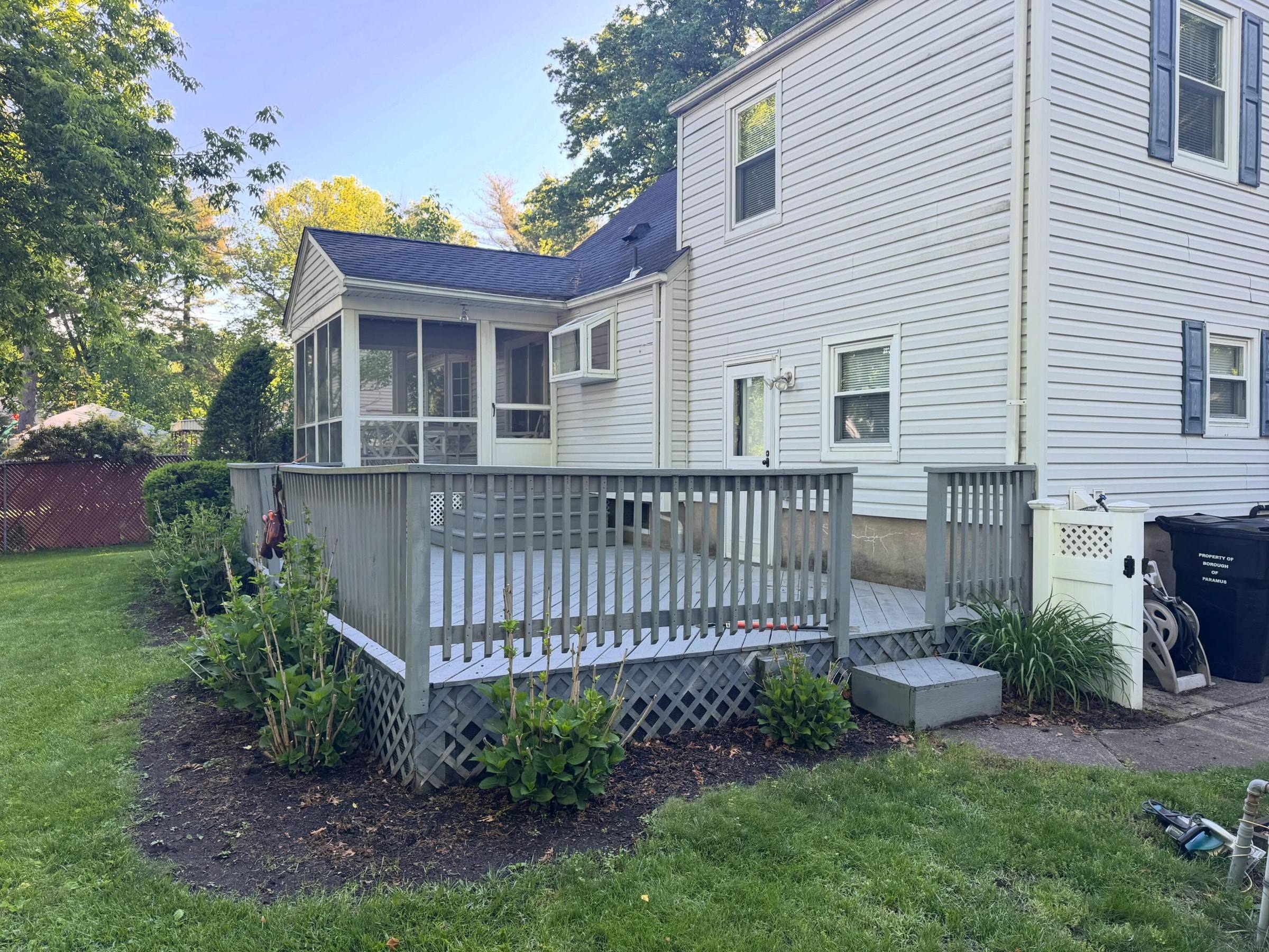 The old gray deck with lattice skirting, before demolition