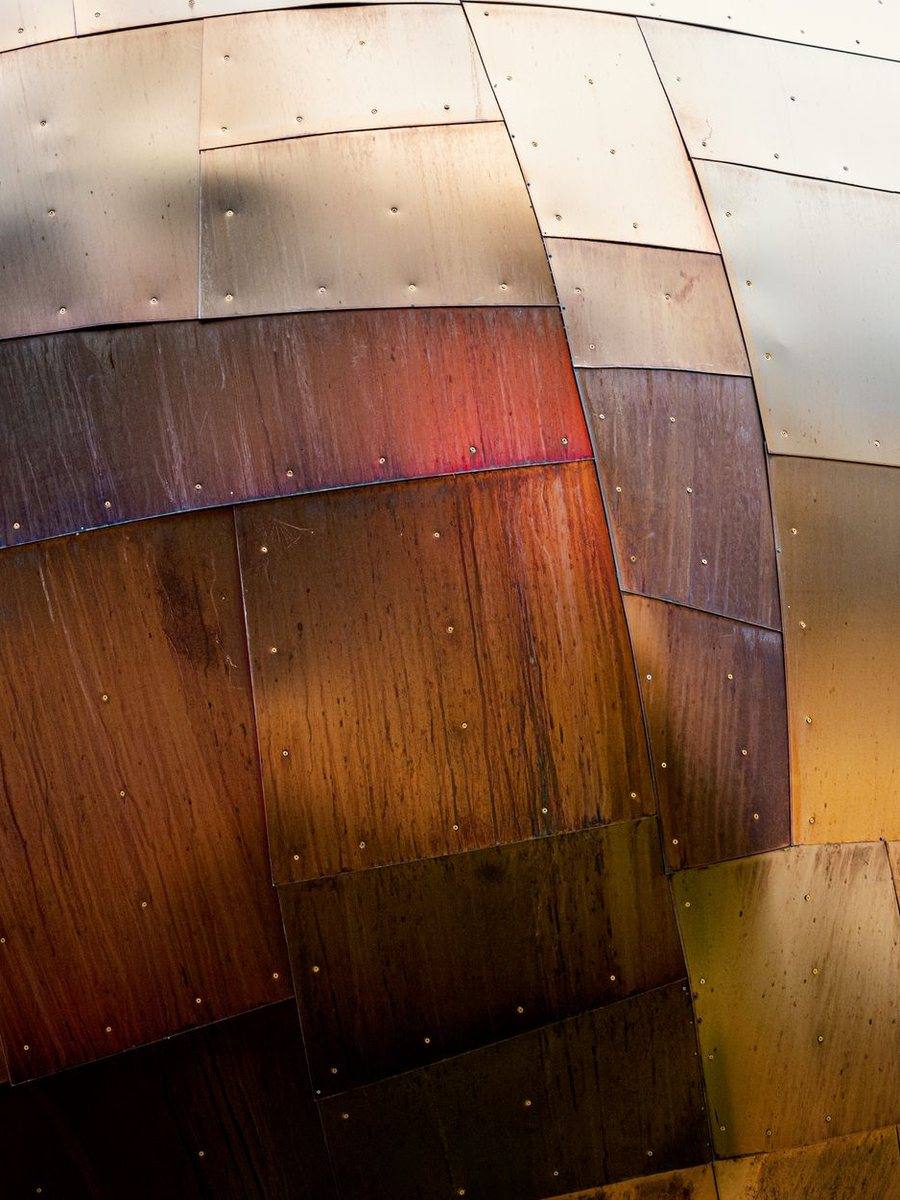 Warm copper panels weathering on an architectural roof