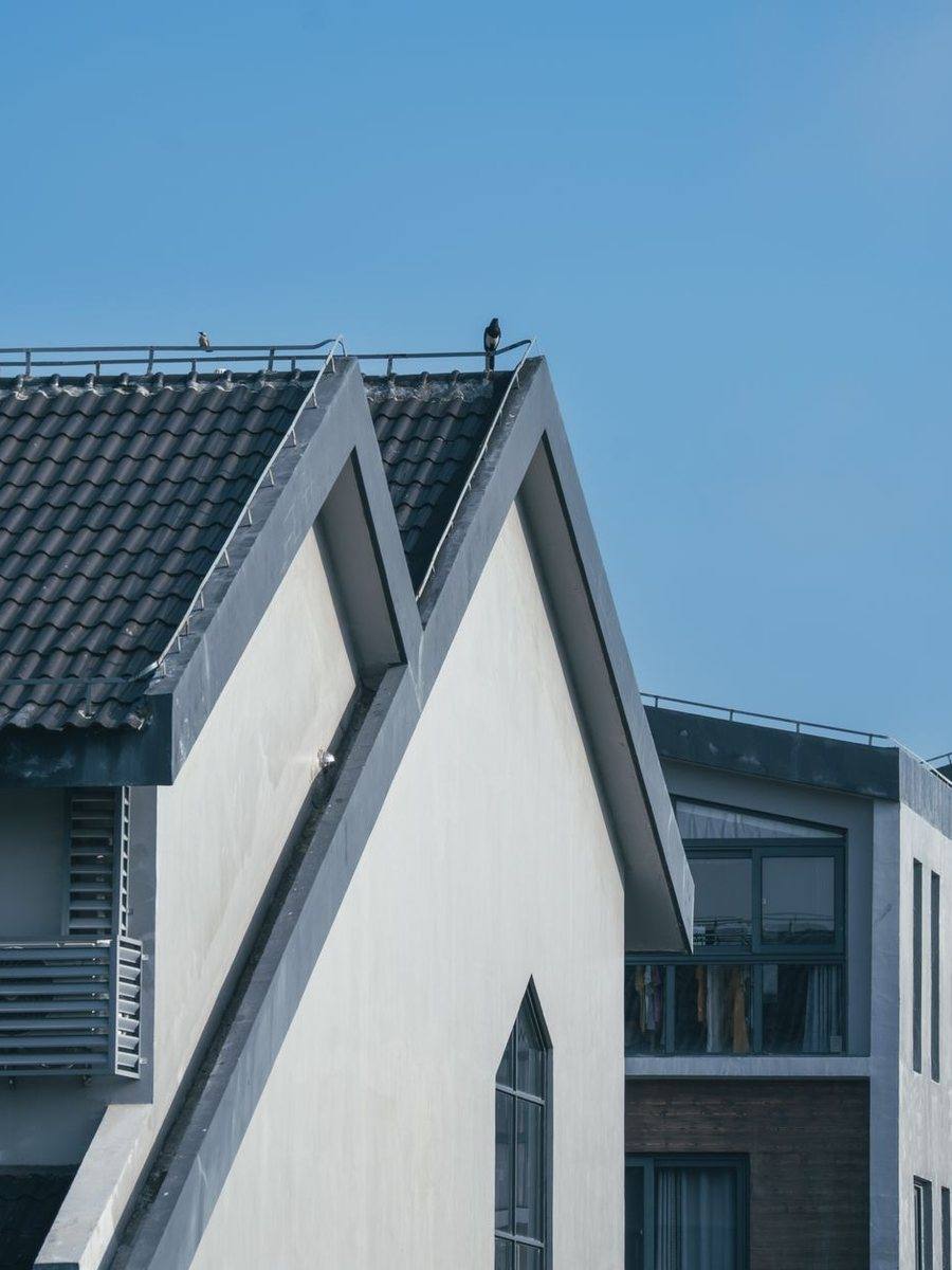 A modern house with a low-slope roof against a blue sky