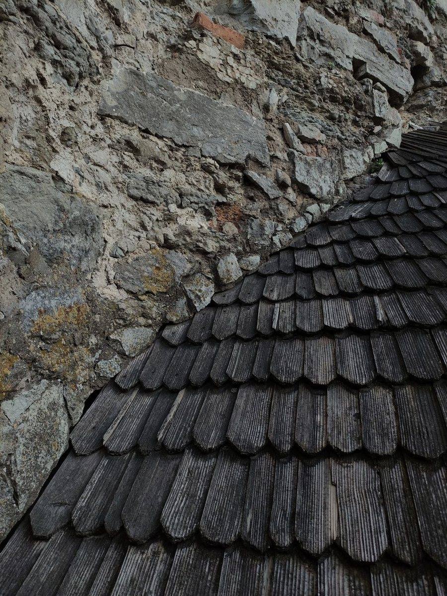 A blue-gray natural slate roof with a small dormer