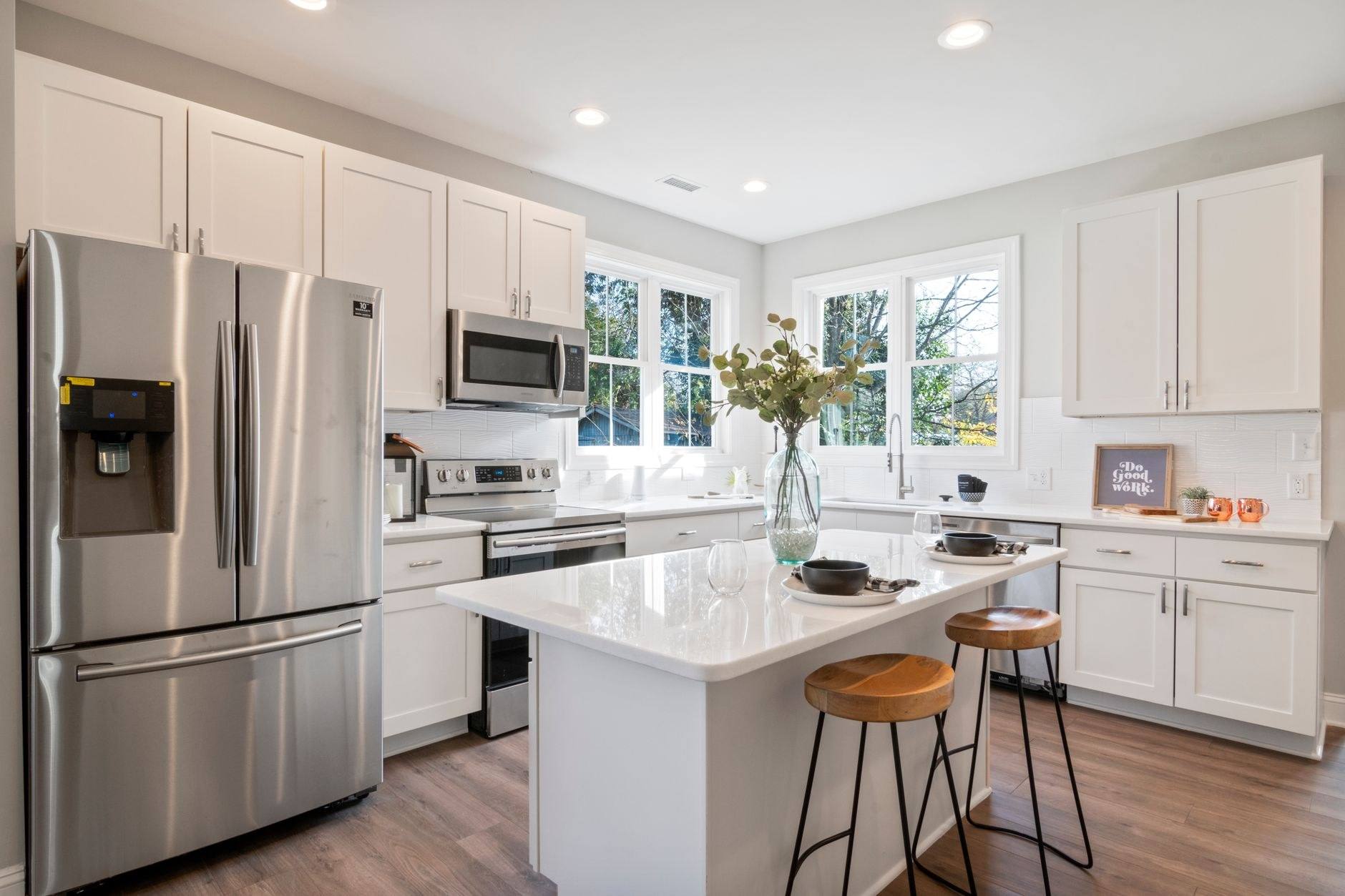 A kitchen part-way through renovation with a fitter working on the cabinetry